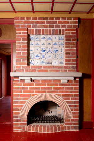 Der Kamin im Wohnzimmer musste weitgehend rekonstruiert werden, nur die Delfter Kacheln berstanden die Jahrzehnte unversehrt.