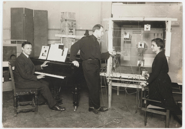 Ludwig Hirschfeld-Mack (l. am Klavier), Theo Bogler (m.), Marli Heiman (r.) an der Apparatur, bei der Auffhrung von Kreuzspiel, um 1924