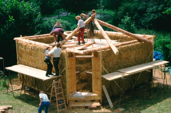 Gernot Minke errichtet auf dem Experimentiergelände in Kassel im Jahr 2000 den ersten Strohballennbau mit tragenden Wänden in Deutschland.